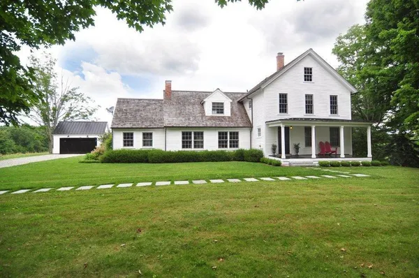 a front view of a house with a garden