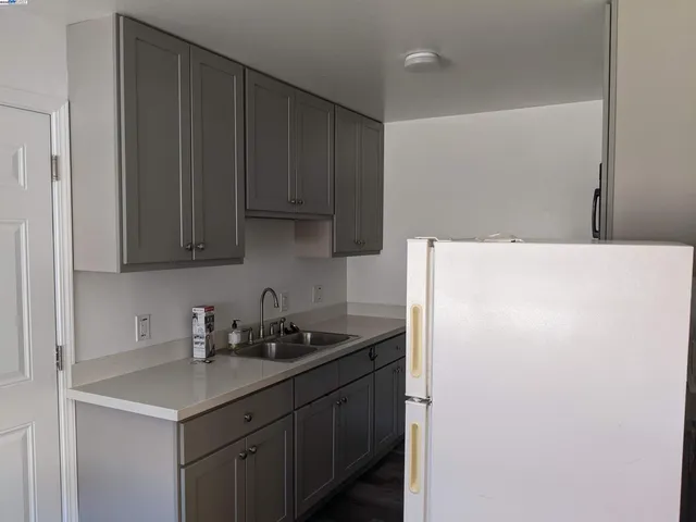 a kitchen with stainless steel appliances a refrigerator and a sink