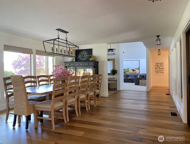 a view of a dining room with furniture window and wooden floor