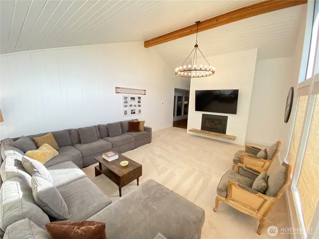 a living room with furniture and a chandelier