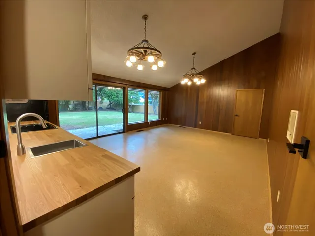 a view of a livingroom with a chandelier furniture and a ceiling fan