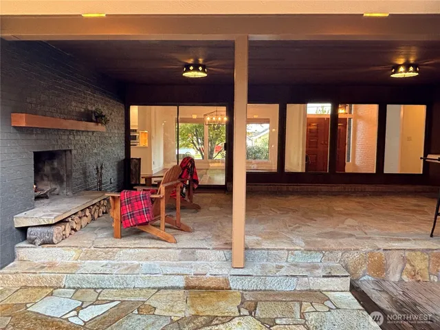 a living room with furniture a window and a fireplace