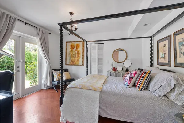 a bed room with a bed and a large window
