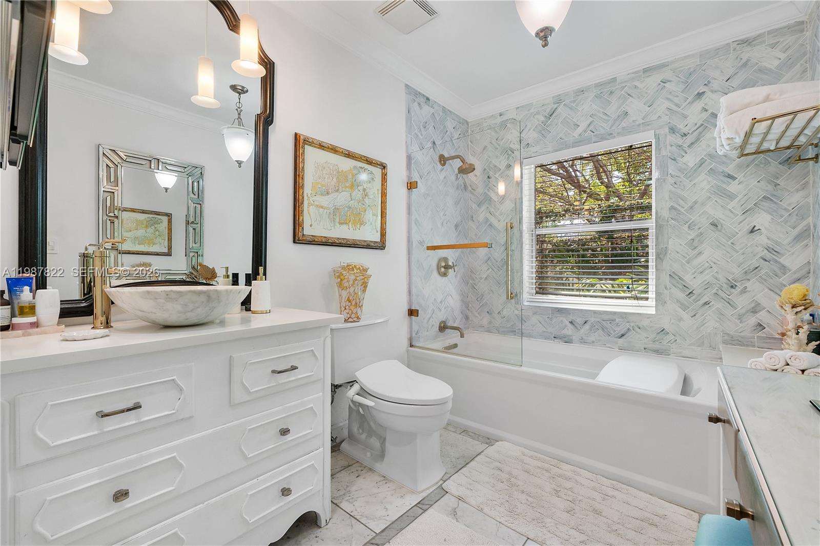 5961 Southwest 46th Terrace Miami, FL 33155 - Photo 18 of 28 a spacious bathroom with a double vanity sink a toilet a mirror and a window