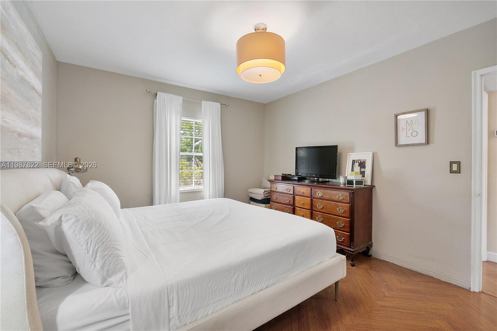5961 Southwest 46th Terrace Miami, FL 33155 - Photo 21 of 28 a bedroom with a bed and a flat screen tv