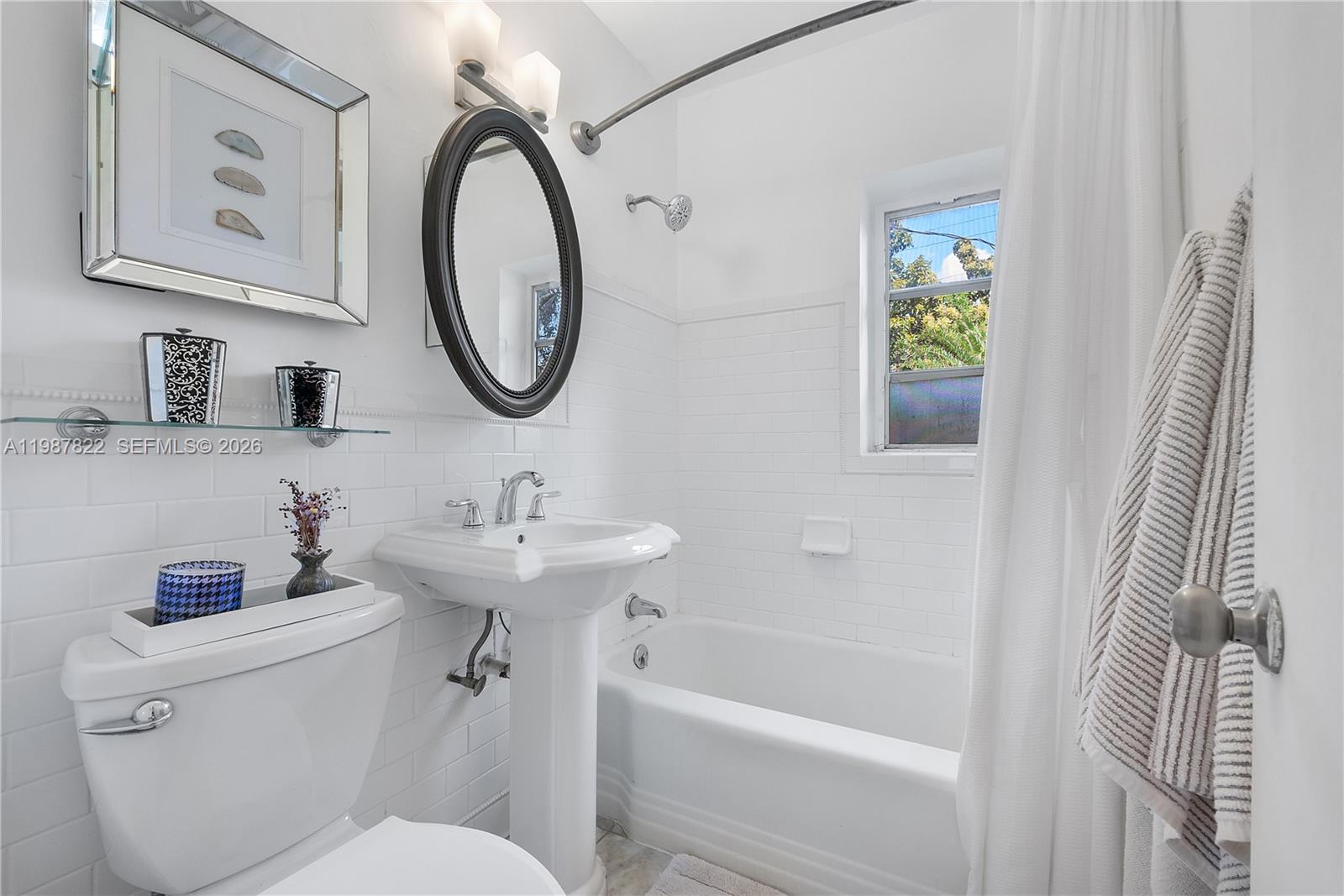 5961 Southwest 46th Terrace Miami, FL 33155 - Photo 22 of 28 a bathroom with a sink a toilet and a mirror