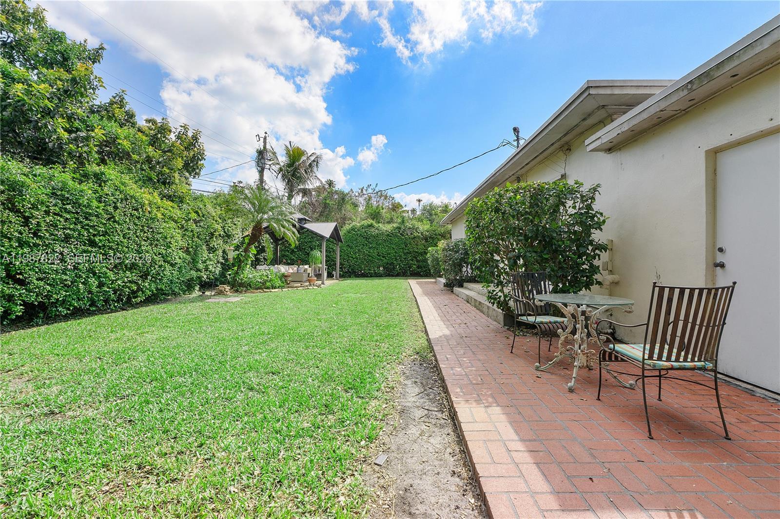 5961 Southwest 46th Terrace Miami, FL 33155 - Photo 26 of 28 a view of a patio with table and chairs and potted plants