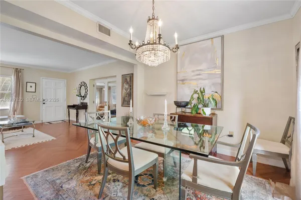 a view of a dining room with furniture wooden floor and chandelier