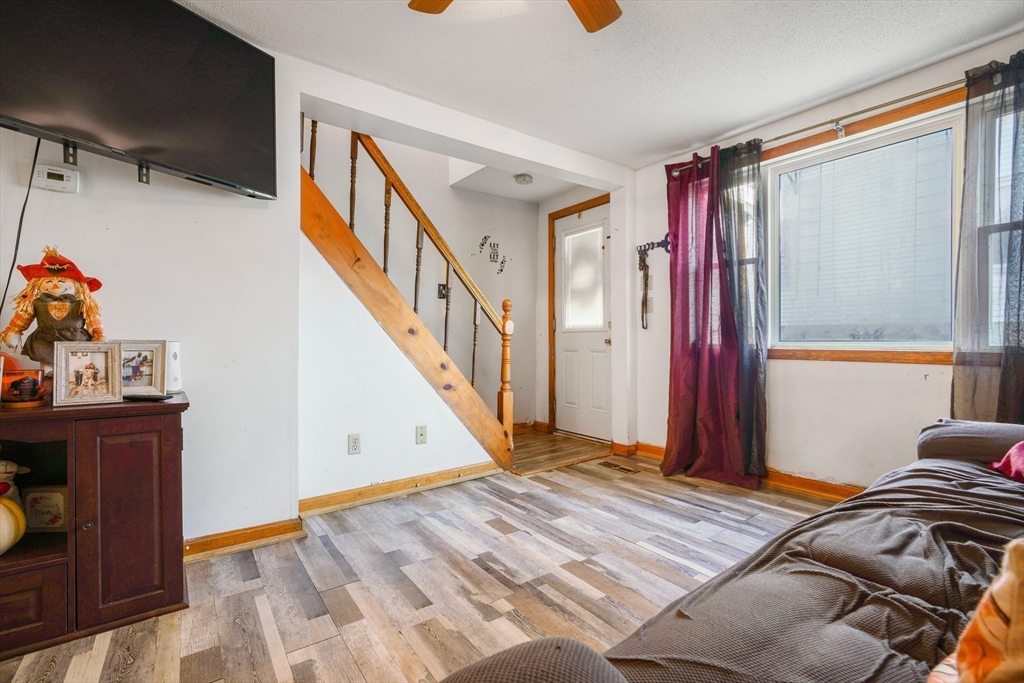 45 Boutwell Street Fall River, MA 02723 - Photo 13 of 36 a view of a bedroom with wooden floor and stairs