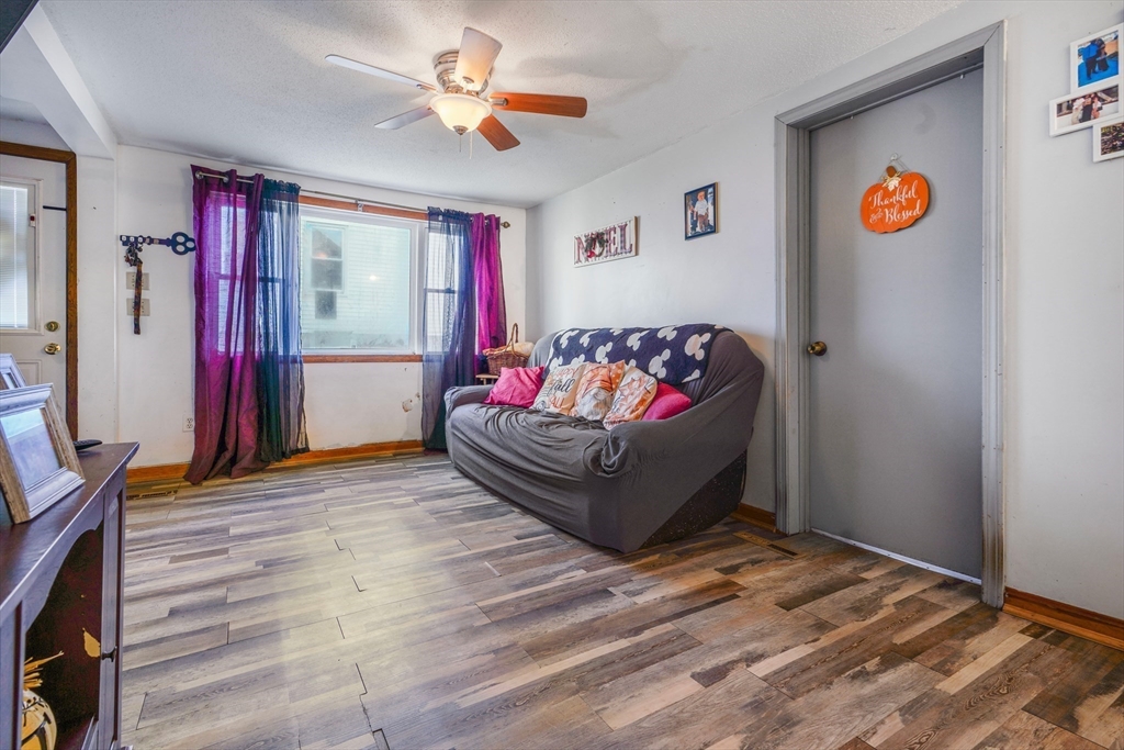 45 Boutwell Street Fall River, MA 02723 - Photo 16 of 36 a living room with furniture and a wooden floor