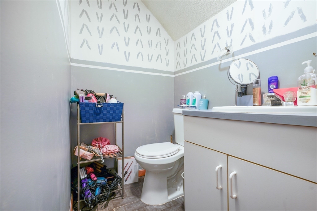 45 Boutwell Street Fall River, MA 02723 - Photo 21 of 36 a bathroom with a sink mirror vanity and toilet