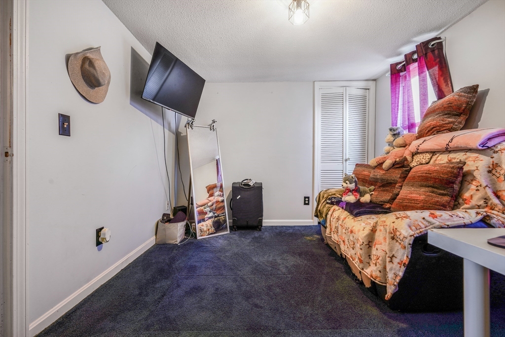 45 Boutwell Street Fall River, MA 02723 - Photo 22 of 36 a bed room with a bed and a television