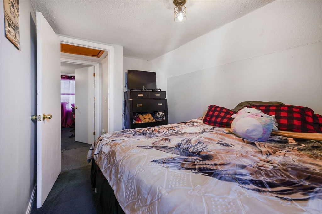 45 Boutwell Street Fall River, MA 02723 - Photo 24 of 36 a bedroom with a bed and a tv