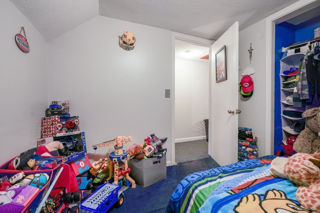 45 Boutwell Street Fall River, MA 02723 - Photo 26 of 36 a bed room with a bed and a couch