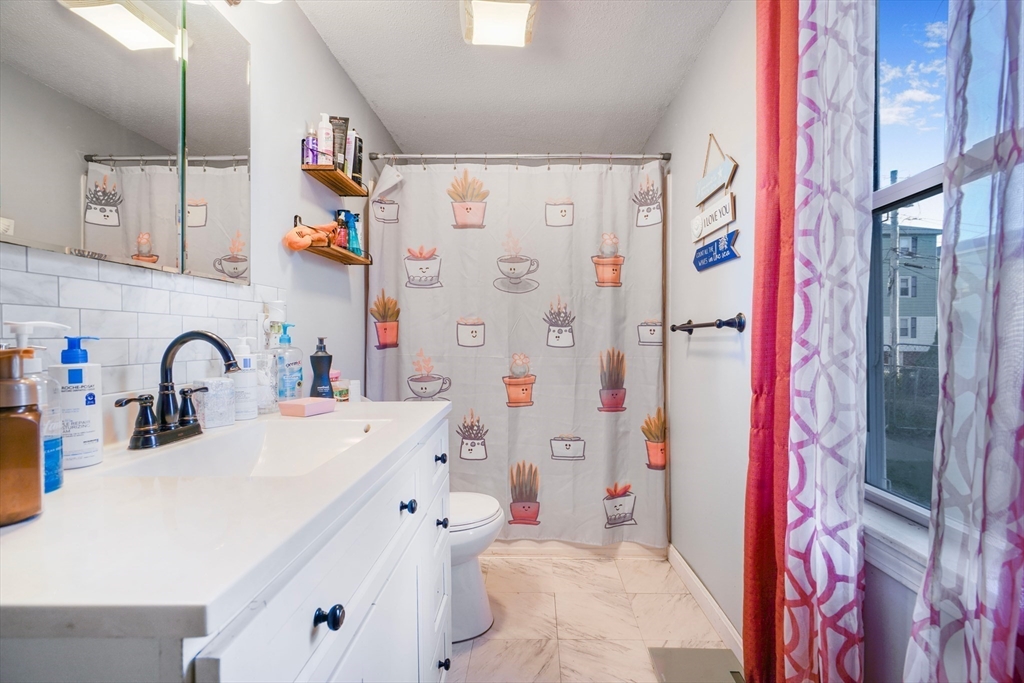 45 Boutwell Street Fall River, MA 02723 - Photo 31 of 36 a bathroom with a sink and a shower curtain