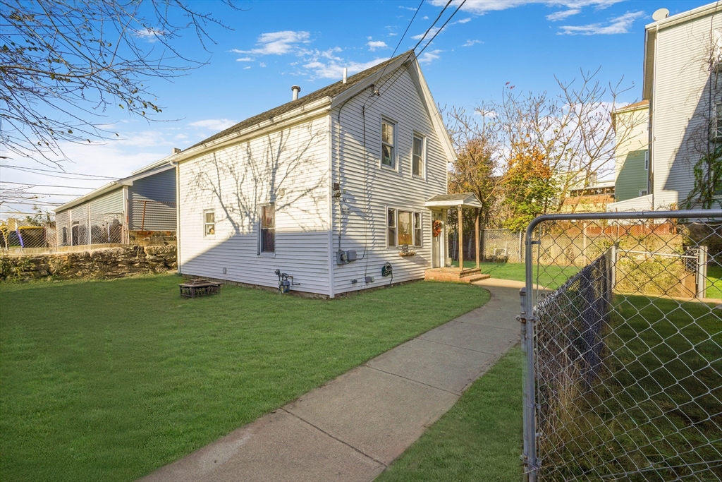 45 Boutwell Street Fall River, MA 02723 - Photo 35 of 36 a front view of a house with garden
