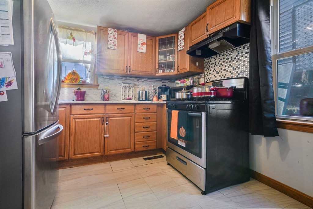 45 Boutwell Street Fall River, MA 02723 - Photo 7 of 36 a kitchen with stainless steel appliances granite countertop a refrigerator and a stove