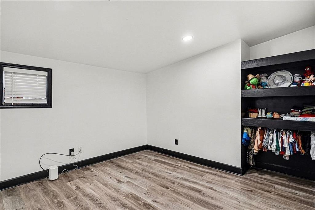 166 Evans Road Griffin, GA 30223 - Photo 25 of 36 a view of an empty room with window and wooden floor