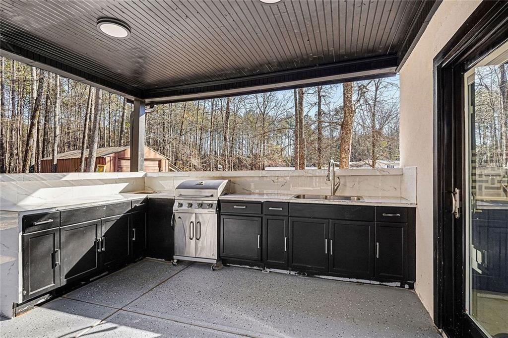 166 Evans Road Griffin, GA 30223 - Photo 27 of 36 a kitchen with stainless steel appliances granite countertop a sink and a stove