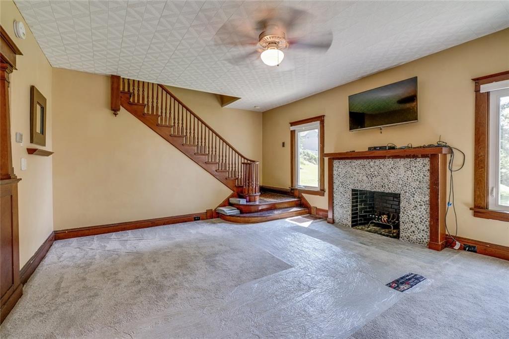 176 Churchill Road Turtle Creek, PA 15145 - Photo 12 of 25 Living room and view of the stairs leading to second floor.