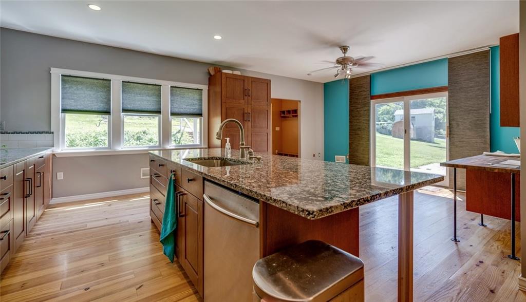 176 Churchill Road Turtle Creek, PA 15145 - Photo 5 of 25 Kitchen and view of the back door mud room area with sliding doors to side patio.