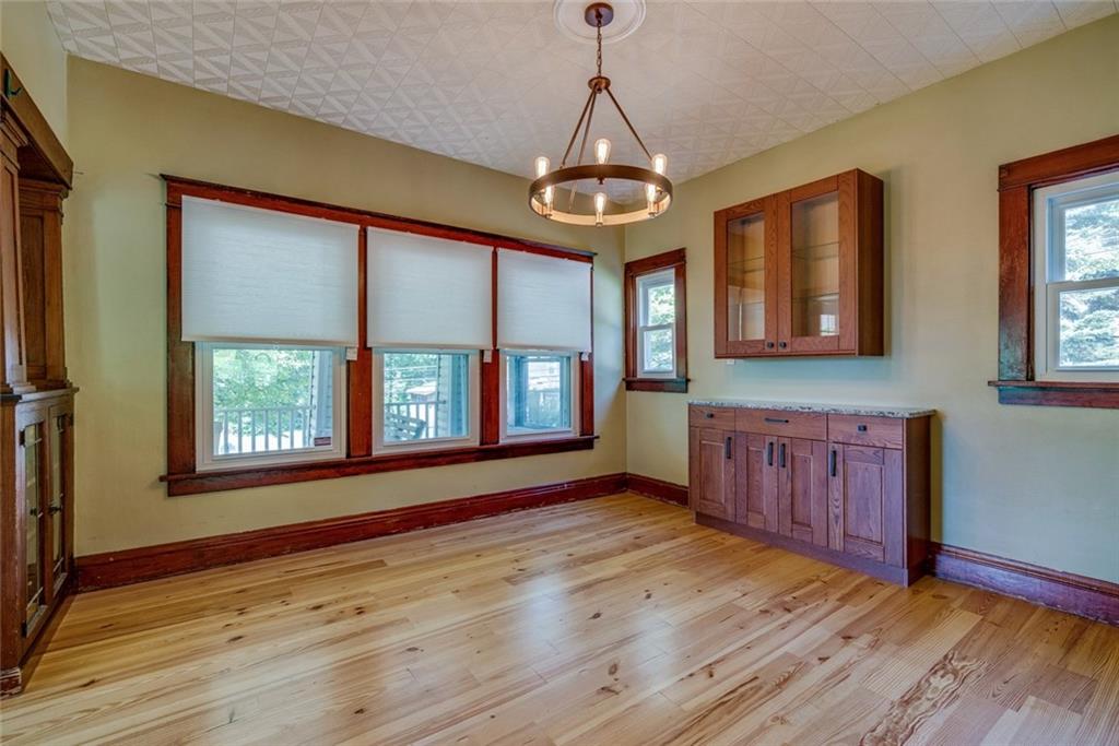 176 Churchill Road Turtle Creek, PA 15145 - Photo 9 of 25 Formal dining room with new hardwood floor and original wooden details. Butler's pantry matching the cabinetry of the kitchen.