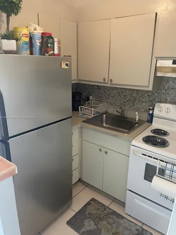 a kitchen with appliances and cabinets