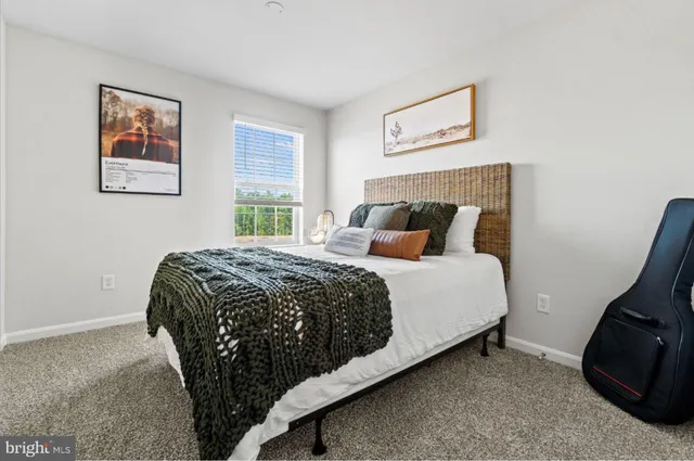 a bedroom with a bed and painting on the wall