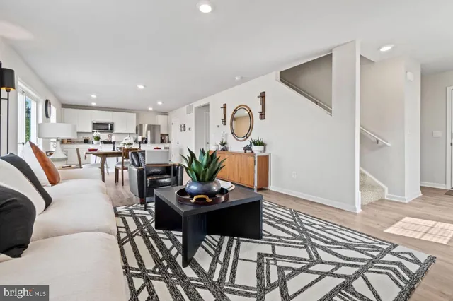 a living room with furniture and kitchen view
