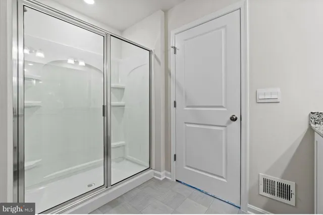 a bathroom with a glass shower door
