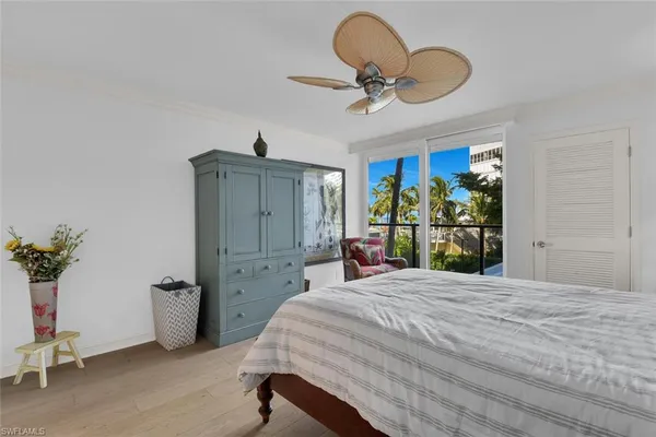 a bedroom with a bed and ceiling fan