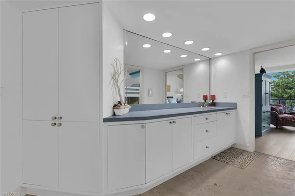 a bathroom with a double vanity sink and a mirror