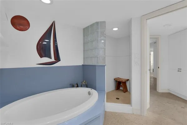 a bathroom with a tub and a window