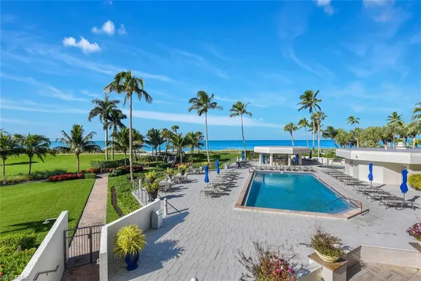 a view of a swimming pool with a patio and a garden
