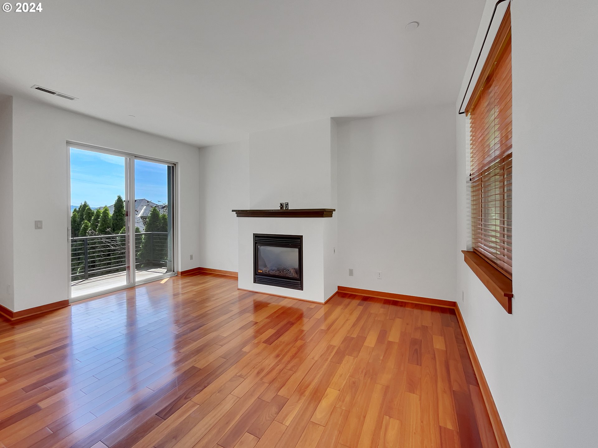 5053 Southwest View Point Terrace Portland, OR 97239 - Photo 3 of 22 a view of an empty room with wooden floor and a window