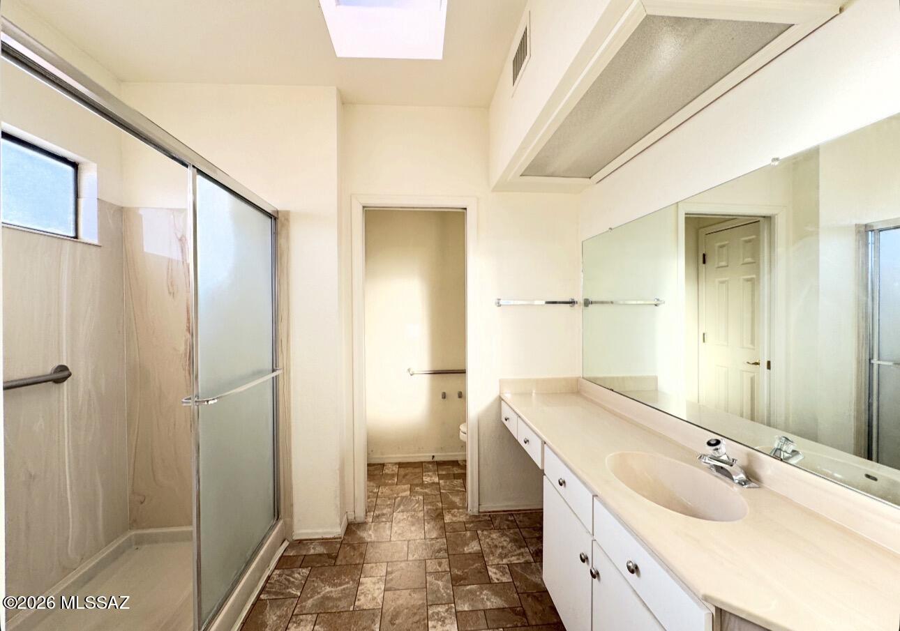 4998 North Valle Road Tucson, AZ 85750 - Photo 8 of 11 a bathroom with a granite countertop sink mirror and double