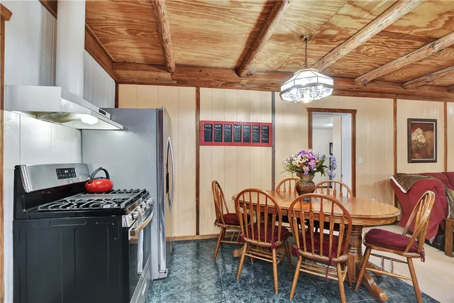 a view of a dining room with furniture and chandelier
