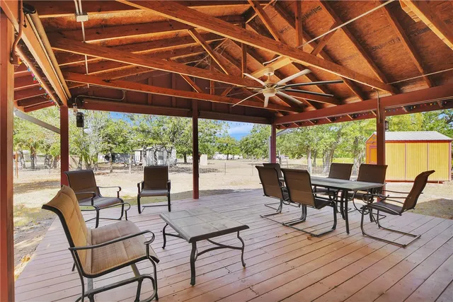 a view of a patio with table and chairs and wooden floor
