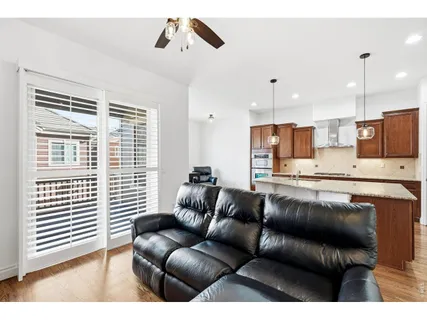 a view of kitchen with kitchen island stainless steel appliances wooden floor and window