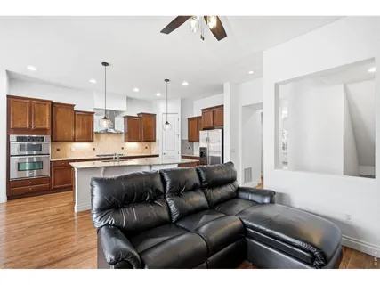 a living room with stainless steel appliances kitchen island granite countertop furniture and a view of kitchen