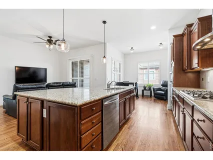 a kitchen with granite countertop a sink appliances counter top space and cabinets