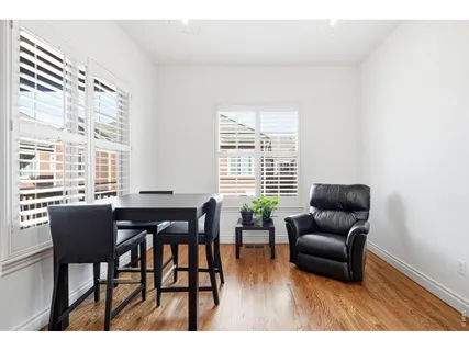 a dining room with furniture and wooden floor