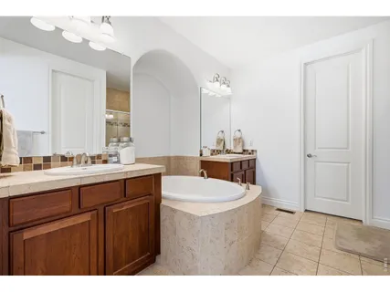 a bathroom with a sink vanity granite and a mirror