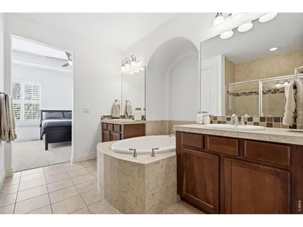 a bathroom with a sink a tub and a mirror