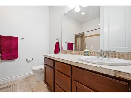 a bathroom with a sink a toilet and a mirror