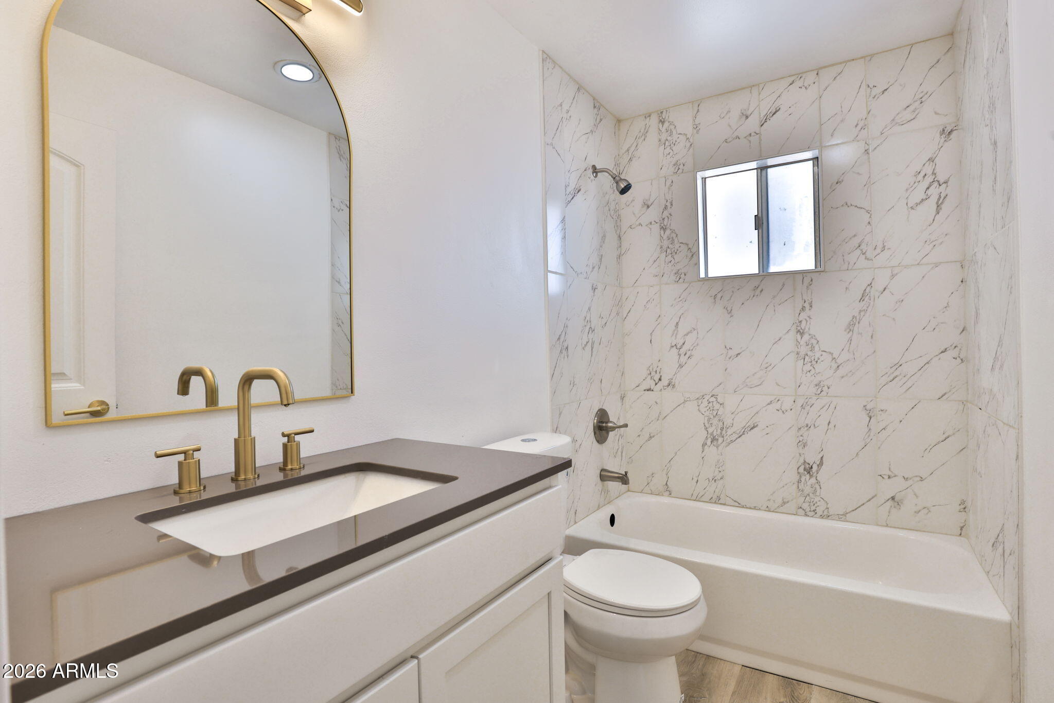 5510 East Dallas Street Mesa, AZ 85205 - Photo 15 of 24 a bathroom with a granite countertop sink a toilet and a bathtub