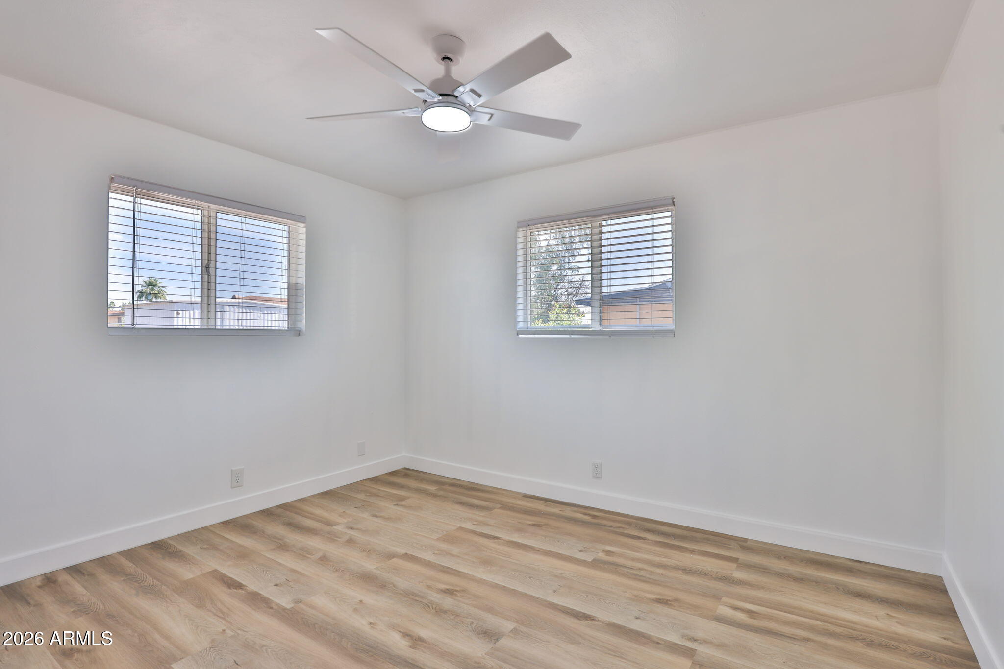 5510 East Dallas Street Mesa, AZ 85205 - Photo 17 of 24 an empty room with wooden floor and window