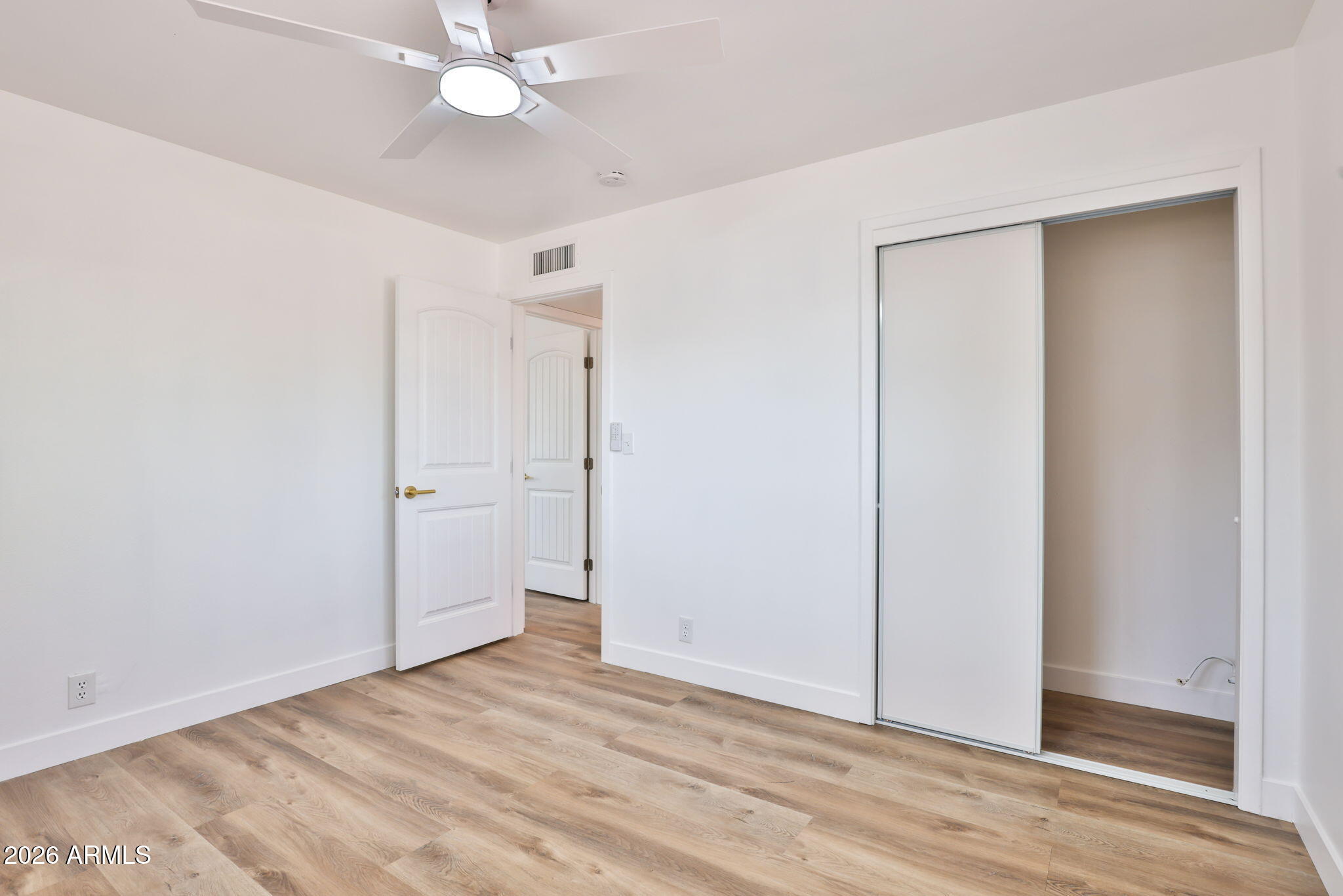5510 East Dallas Street Mesa, AZ 85205 - Photo 18 of 24 a view of an empty room with window and wooden floor
