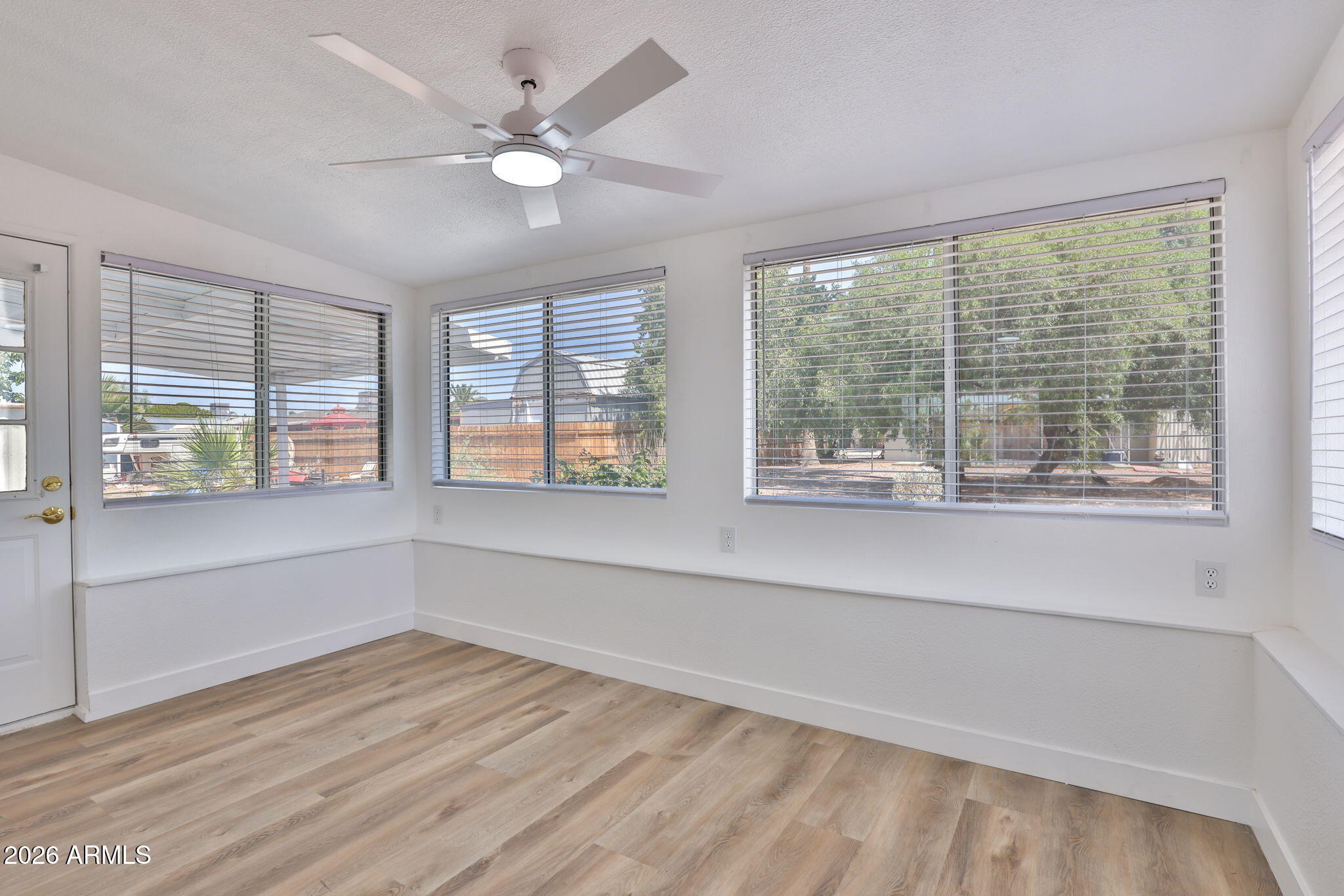 5510 East Dallas Street Mesa, AZ 85205 - Photo 19 of 24 a view of an empty room with a window and a kitchen view