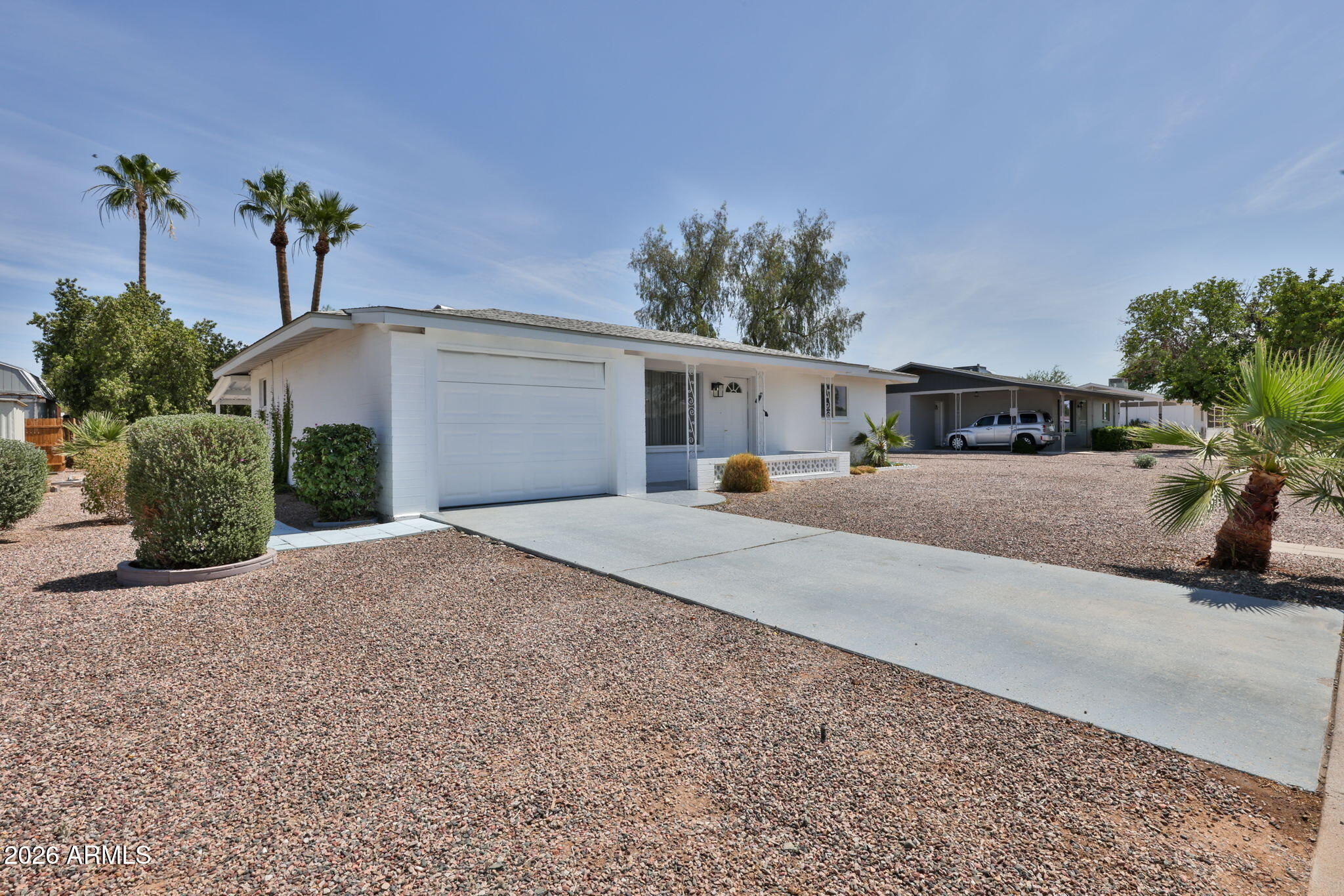5510 East Dallas Street Mesa, AZ 85205 - Photo 2 of 24 a view of a house with a yard and palm trees